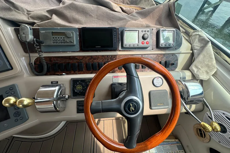 Slide: The Image of Helm of 1998 Sea Ray 450 Sundancer with wooden steering wheel and navigation instruments. - 20