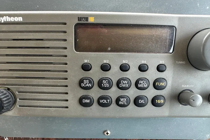 Slide: The Image of Raytheon Ray210 VHF radio on 1998 Sea Ray 450 Sundancer boat dashboard. - 24