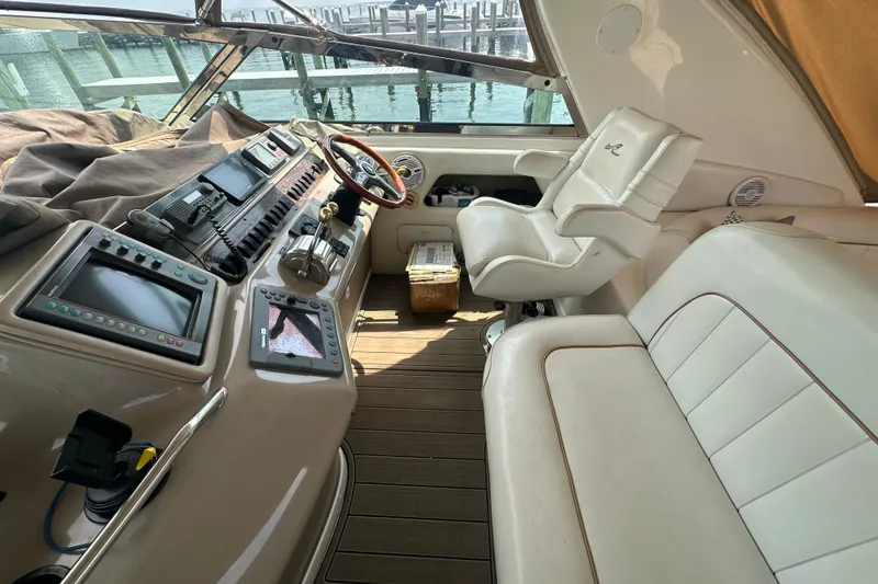 Slide: The Image of Interior of a 1998 Sea Ray 450 Sundancer yacht with helm and seating area. - 25