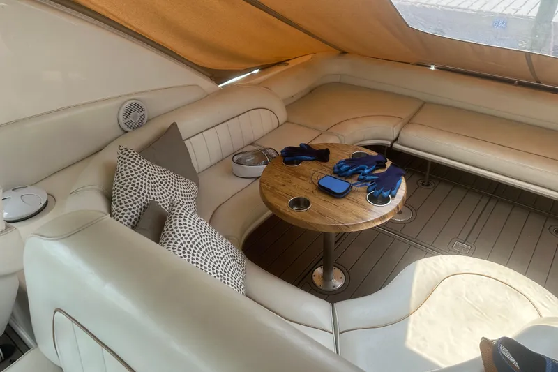 Slide: The Image of Luxurious interior of 1998 Sea Ray 450 Sundancer yacht with plush seating and wooden table. - 27