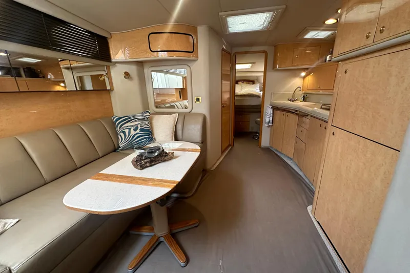 Slide: The Image of Luxurious interior of 1998 Sea Ray 450 Sundancer yacht with modern kitchen and seating area. - 3
