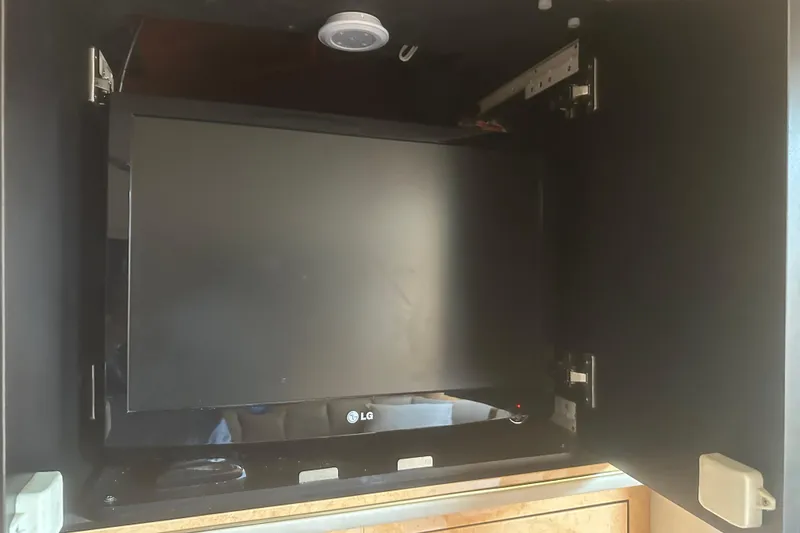 Slide: The Image of LG TV mounted inside a cabinet on a 1998 Sea Ray 450 Sundancer yacht. - 4