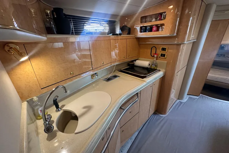 Slide: The Image of Luxurious 1998 Sea Ray 450 Sundancer yacht kitchen with modern amenities and sleek design. - 6
