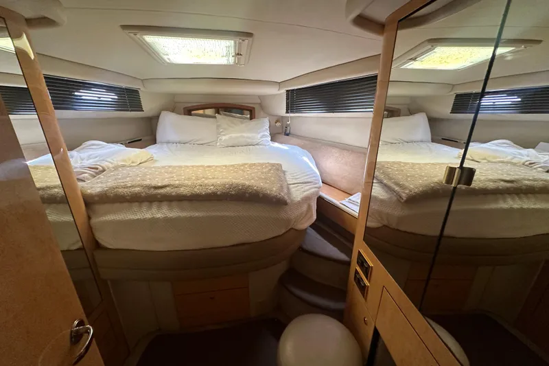 Slide: The Image of Luxurious cabin interior of a 1998 Sea Ray 450 Sundancer yacht with cozy bedding. - 9