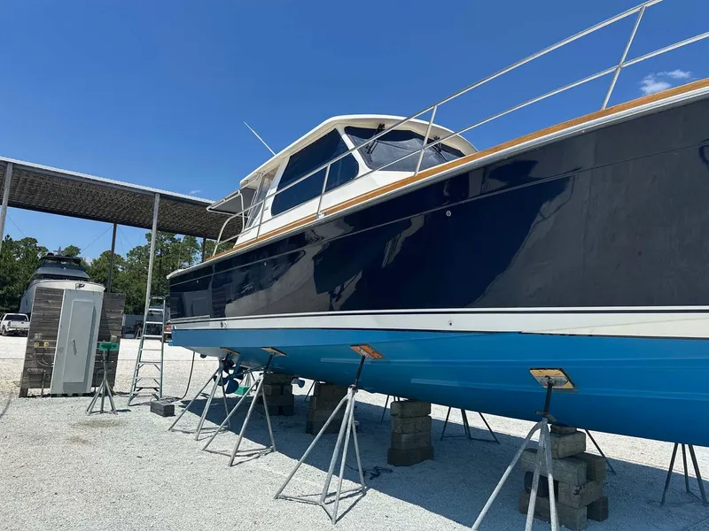 Slide: The Image of 2005 Sabre 42 Express boat on stands, blue hull, outdoor storage. - 34