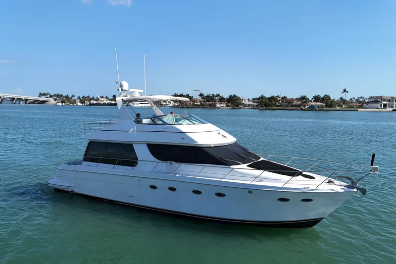 The Image of 1999 Carver 530 Voyager Pilothouse yacht cruising on a sunny day. - 1