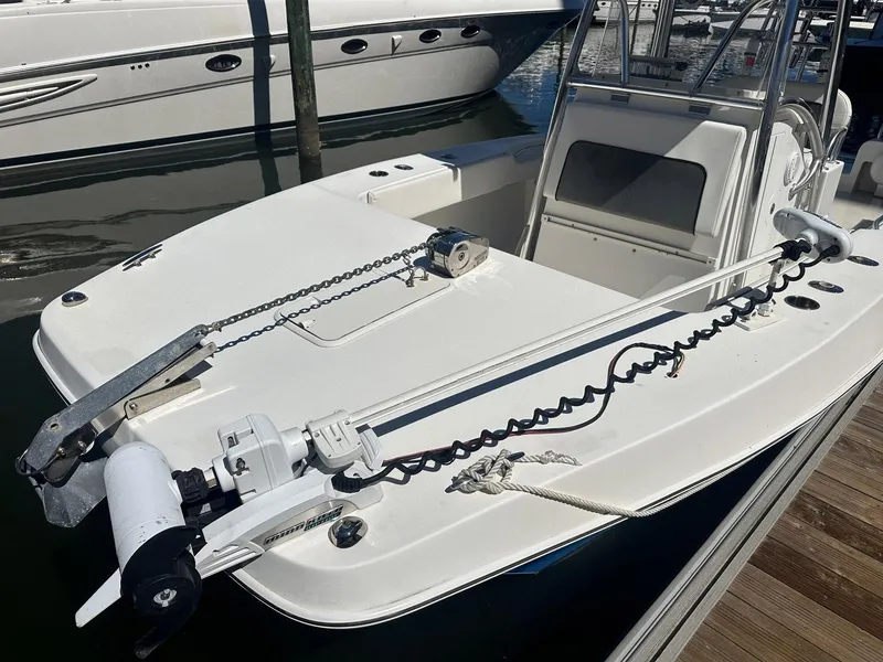 Slide: The Image of 2017 Twin Vee 26 GF boat docked, featuring a spacious deck and modern design. - 4