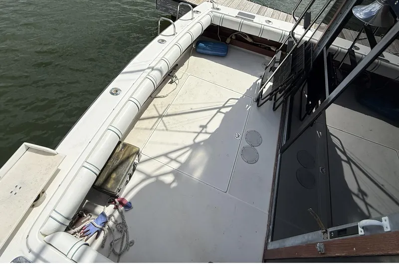 Slide: The Image of 1989 Tiara Yachts 3100 Flybridge deck with seating and dock view. - 12
