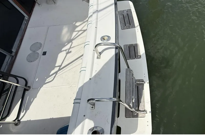 Slide: The Image of 1989 Tiara Yachts 3100 Flybridge deck with stainless steel railings and water view. - 13