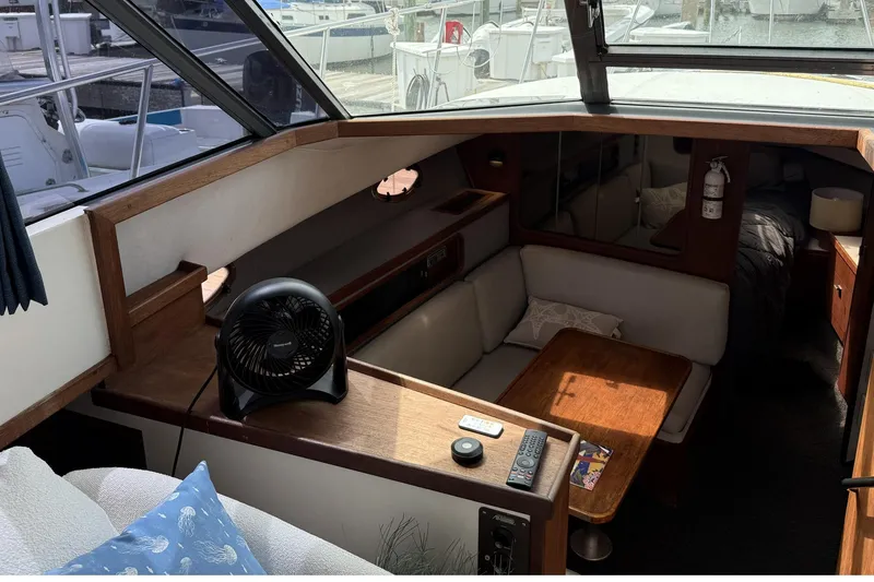 Slide: The Image of 1989 Tiara Yachts 3100 Flybridge interior with seating, table, and fan. - 20