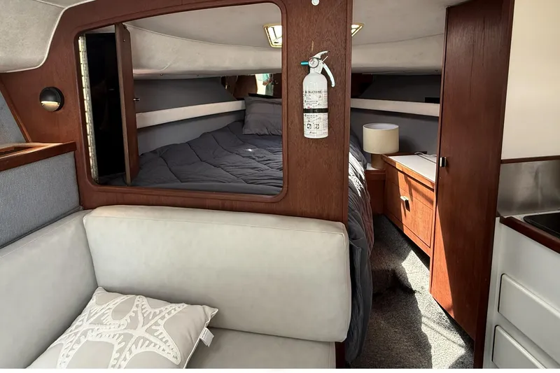 Slide: The Image of Interior of 1989 Tiara Yachts 3100 Flybridge with cozy cabin and wooden furnishings. - 24