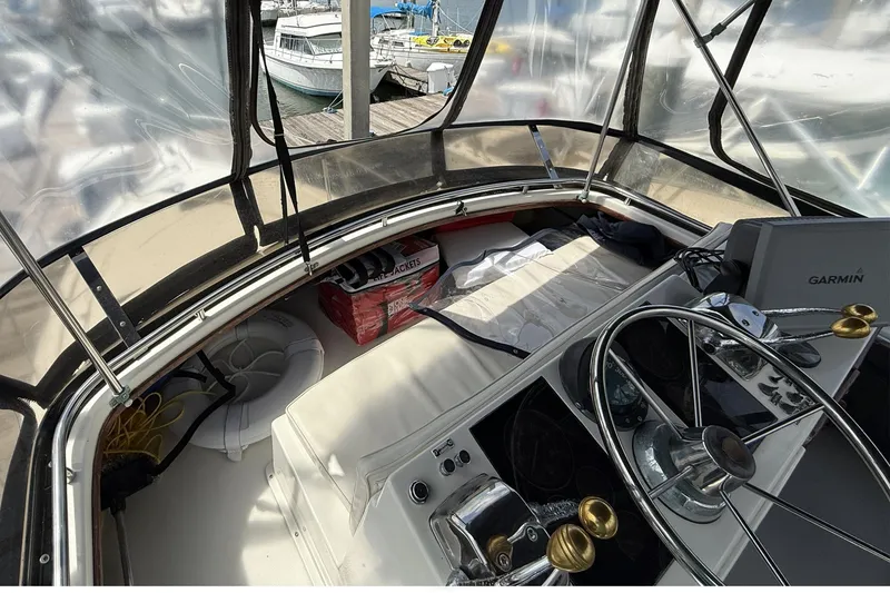 Slide: The Image of 1989 Tiara Yachts 3100 Flybridge cockpit with steering wheel and navigation equipment. - 29
