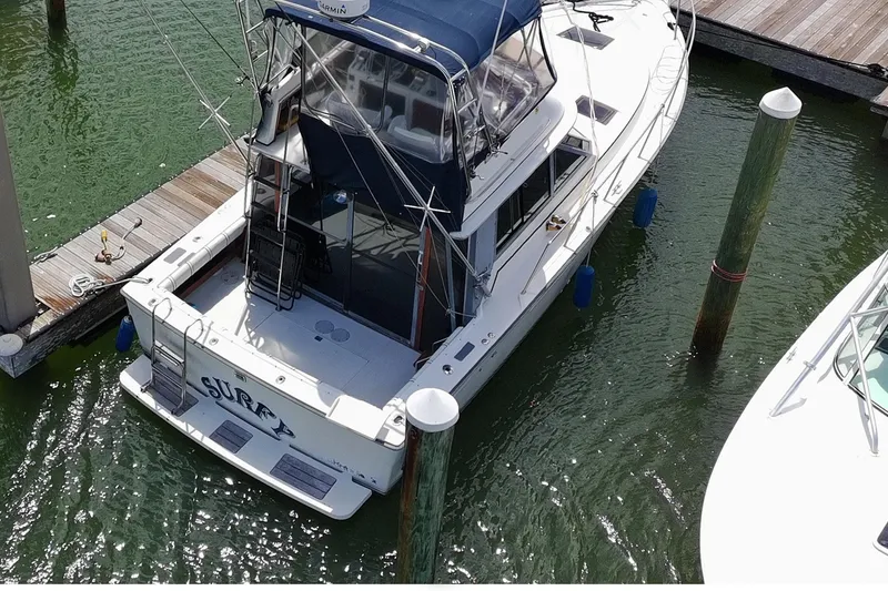 Slide: The Image of 1989 Tiara Yachts 3100 Flybridge docked at marina, aerial view. - 3
