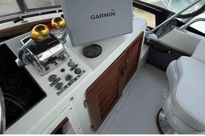 Slide: The Image of 1989 Tiara Yachts 3100 Flybridge helm with Garmin navigation and control panel. - 31