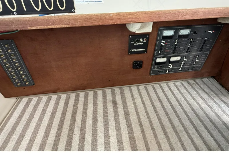 Slide: The Image of Control panel of a 1989 Tiara Yachts 3100 Flybridge with striped carpet flooring. - 36