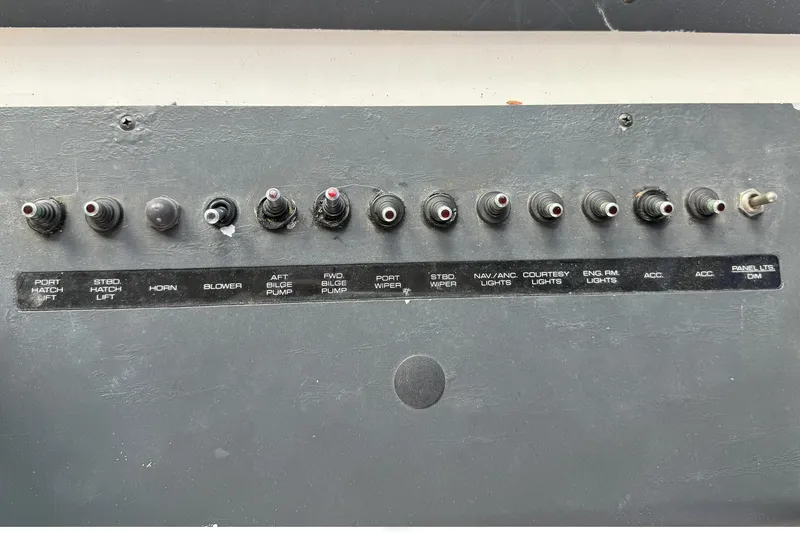 Slide: The Image of Control panel of a 1989 Tiara Yachts 3100 Flybridge with labeled switches. - 37