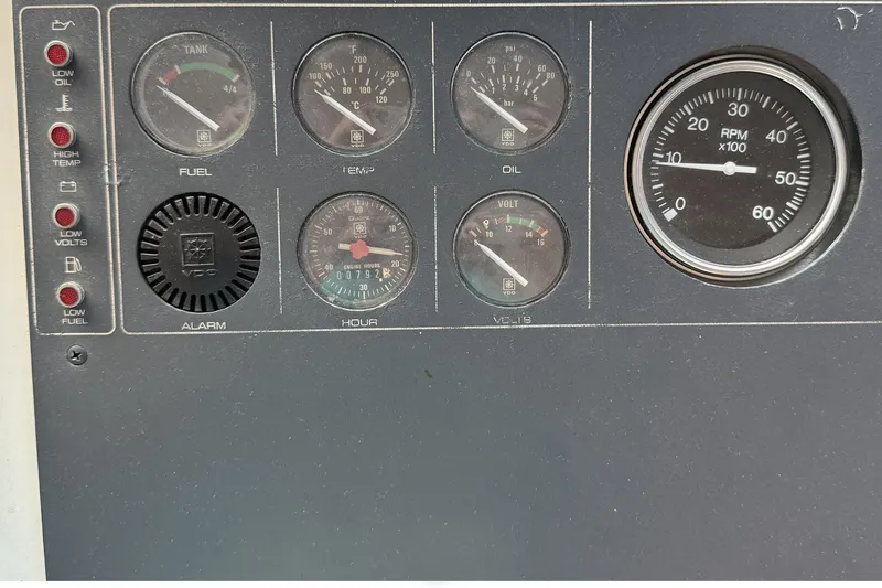 Slide: The Image of Dashboard of a 1989 Tiara Yachts 3100 Flybridge with gauges and indicators. - 38