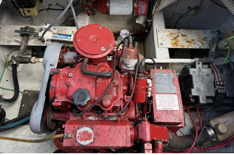 Slide: The Image of Engine compartment of a 1989 Tiara Yachts 3100 Flybridge, featuring a red engine. - 42