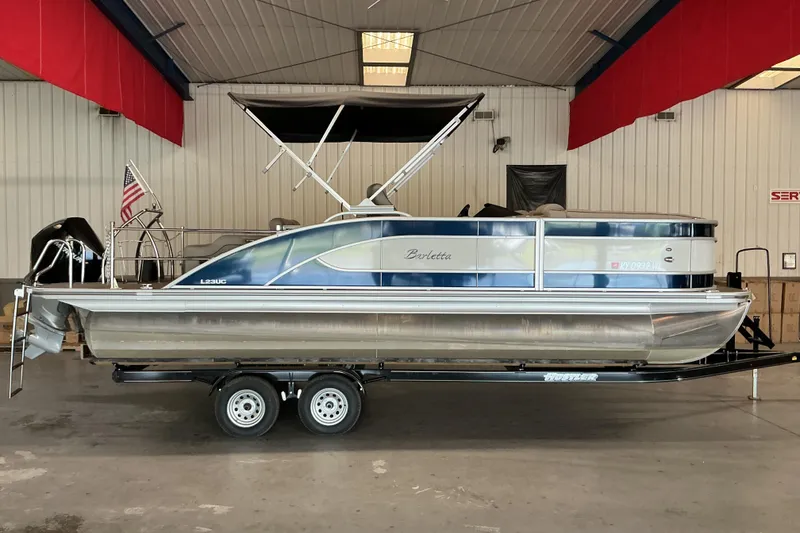 The Image of 2021 Barletta L23UC pontoon boat on trailer in indoor storage facility. - 12