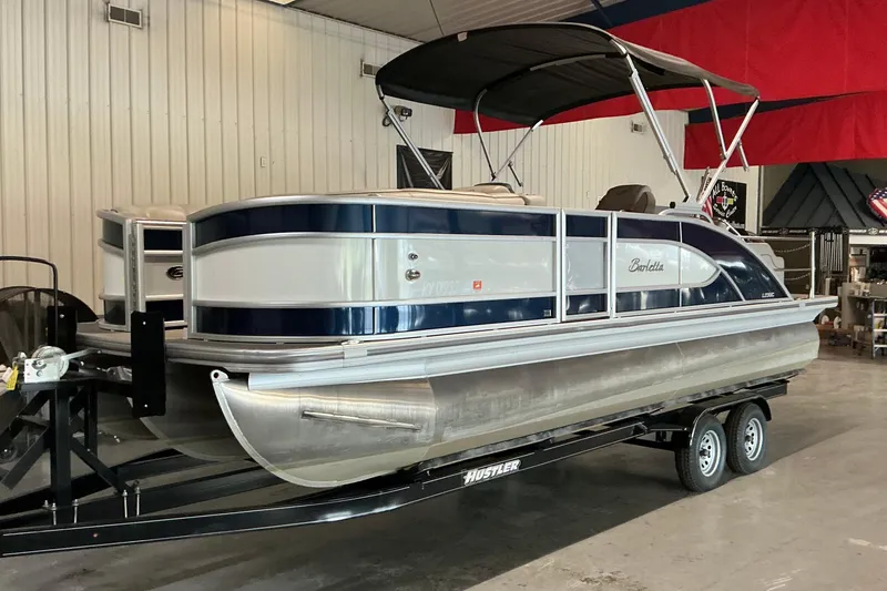 Slide: The Image of 2021 Barletta L23UC pontoon boat on trailer in indoor showroom. - 15