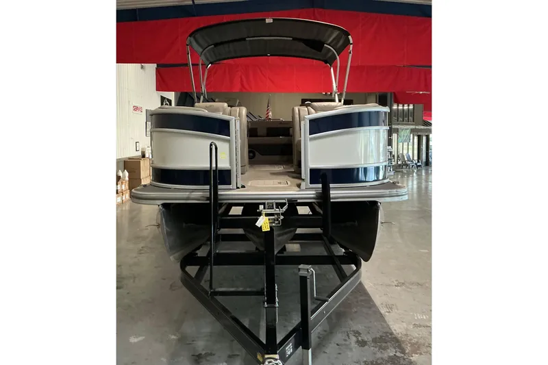 Slide: The Image of 2021 Barletta L23UC pontoon boat in indoor storage, front view. - 19
