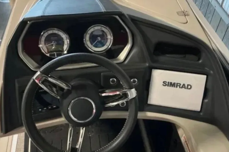 Slide: The Image of Steering console of 2021 Barletta L23UC boat with Simrad display and gauges. - 24