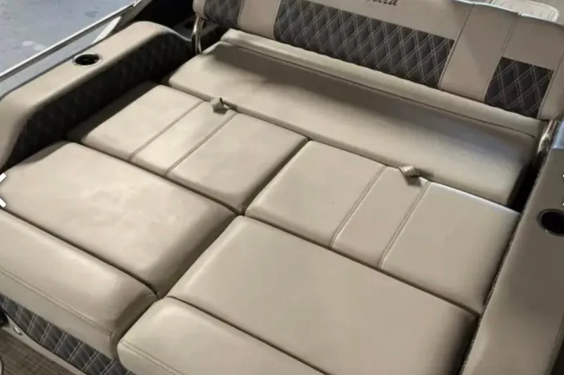 Slide: The Image of 2021 Barletta L23UC boat interior with beige cushioned seating. - 25