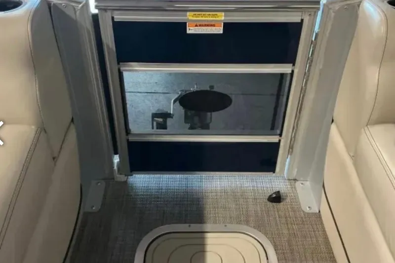 Slide: The Image of Interior view of a 2021 Barletta L23UC boat, featuring seating and flooring details. - 27