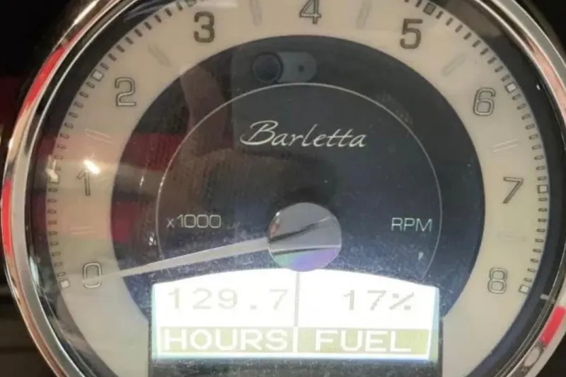 Slide: The Image of Close-up of Barletta L23UC 2021 tachometer showing 129.7 hours and 17% fuel. - 29