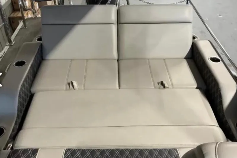 Slide: The Image of 2021 Barletta L23UC boat interior with beige seating and cup holders. - 30