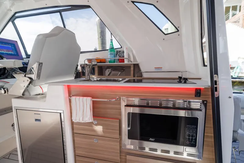 Slide: The Image of Manufacturer Provided Image: Interior of 2026 Solara S-310 SB boat with modern kitchenette and seating. - 5