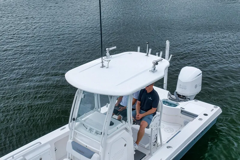 Slide: The Image of 2018 Everglades 243 Center Console boat on water, featuring a sleek design and powerful engine. - 10