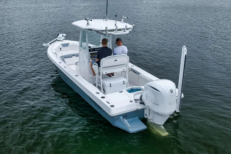 Slide: The Image of 2018 Everglades 243 Center Console boat on water, rear view with two people onboard. - 11