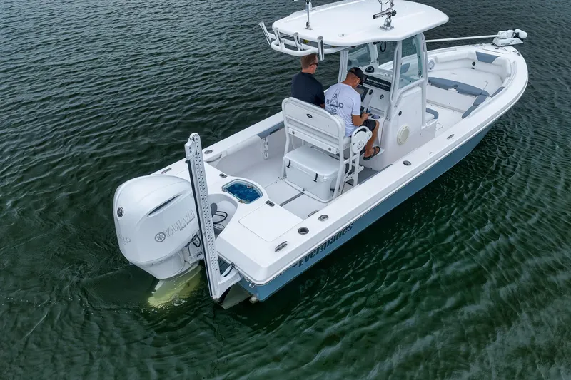 Slide: The Image of 2018 Everglades 243 Center Console boat on water, featuring Yamaha outboard engine. - 13