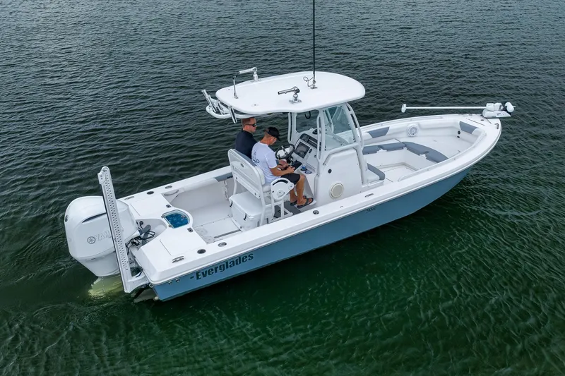 Slide: The Image of 2018 Everglades 243 Center Console boat cruising on calm water. - 14