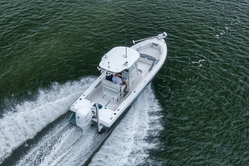 Slide: The Image of 2018 Everglades 243 Center Console boat cruising on open water. - 17