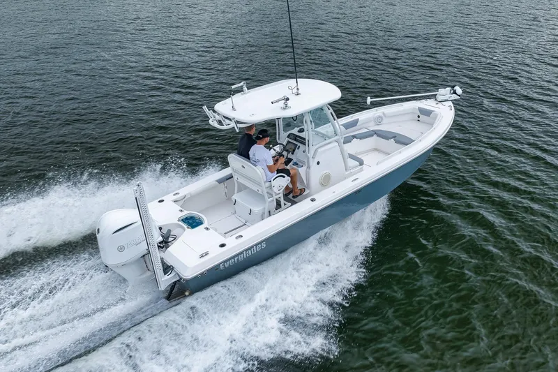 Slide: The Image of 2018 Everglades 243 Center Console boat cruising on open water. - 18