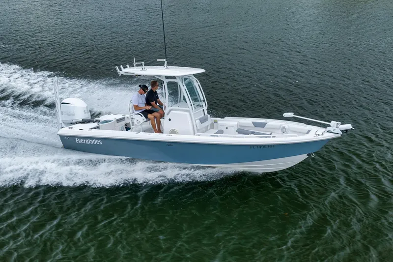 Slide: The Image of 2018 Everglades 243 Center Console boat cruising on water. - 19