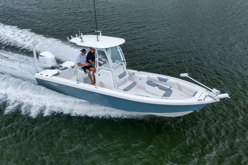 Slide: The Image of 2018 Everglades 243 Center Console boat cruising on open water. - 20