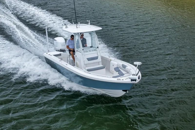 Slide: The Image of 2018 Everglades 243 Center Console boat cruising on open water. - 23