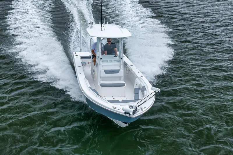 Slide: The Image of 2018 Everglades 243 Center Console boat cruising on open water. - 25