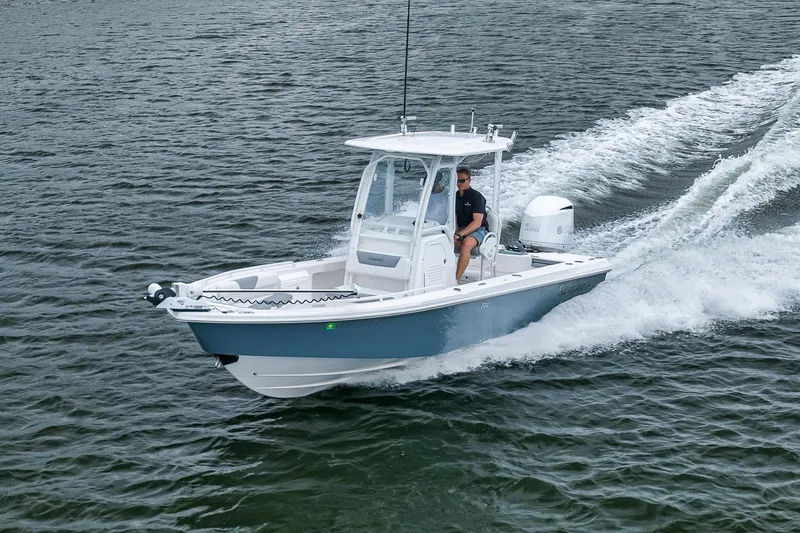 Slide: The Image of 2018 Everglades 243 Center Console boat cruising on open water. - 26