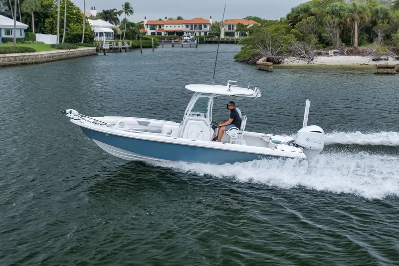 Slide: The Image of 2018 Everglades 243 Center Console boat cruising on a scenic waterway. - 28