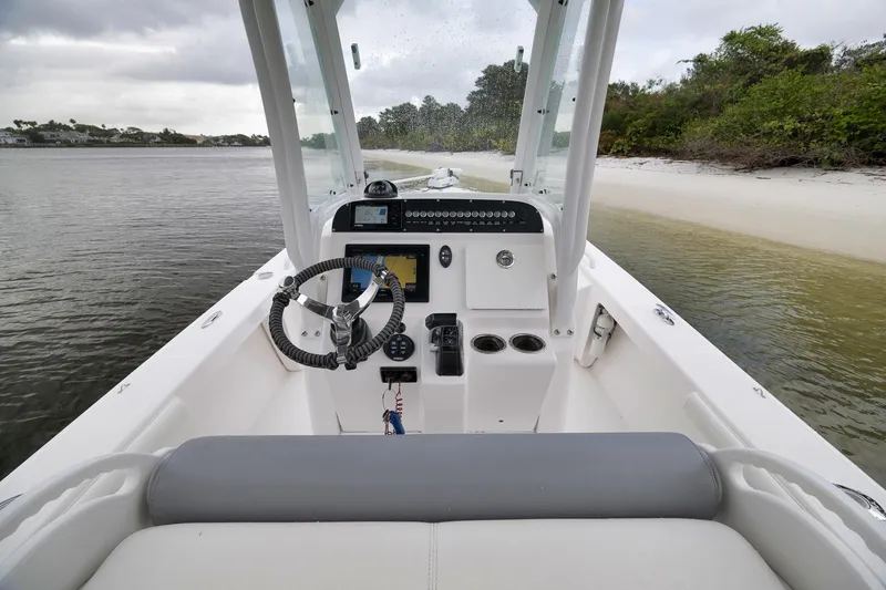 Slide: The Image of 2018 Everglades 243 Center Console boat interior with steering wheel and control panel. - 39