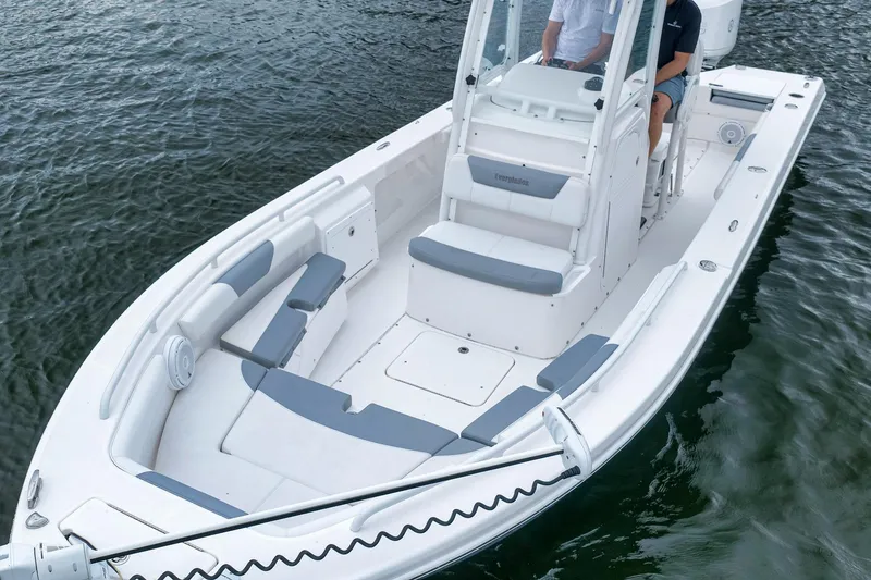 Slide: The Image of 2018 Everglades 243 Center Console boat on water, featuring spacious seating and modern design. - 4