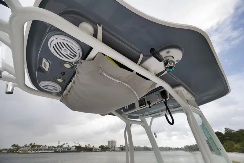 Slide: The Image of 2018 Everglades 243 Center Console boat's overhead console with speakers and storage. - 41