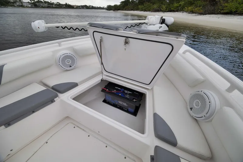 Slide: The Image of 2018 Everglades 243 Center Console boat with open storage compartment and speakers. - 45