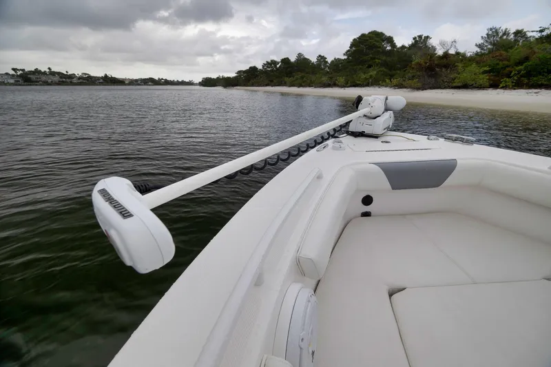 Slide: The Image of 2018 Everglades 243 Center Console boat with trolling motor near a sandy shoreline. - 47