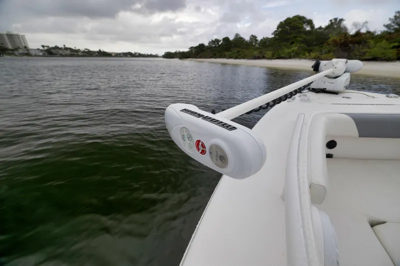 Slide: The Image of 2018 Everglades 243 Center Console boat with trolling motor on calm water. - 48