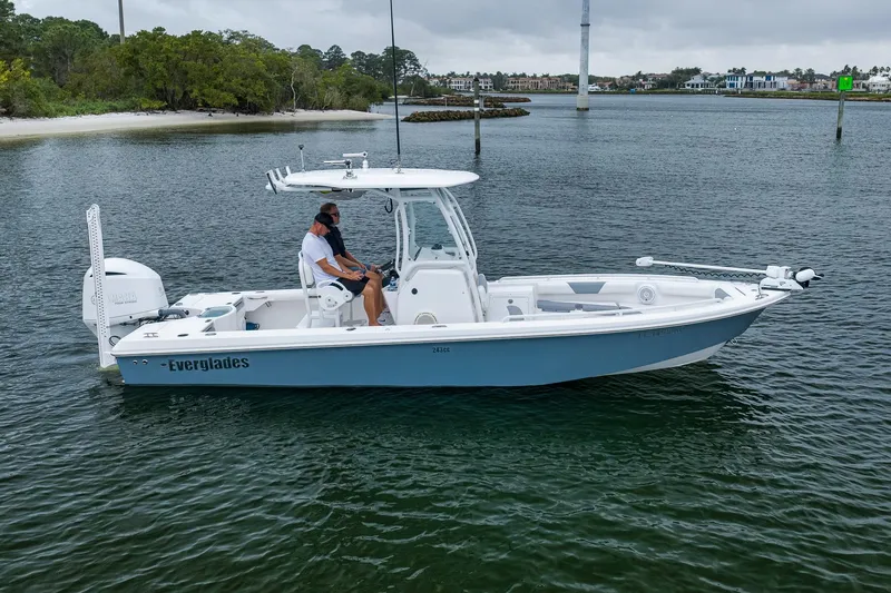 Slide: The Image of 2018 Everglades 243 Center Console boat on calm water, featuring sleek design and modern amenities. - 5